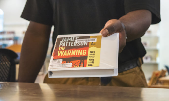 Someone holding an audiobook on CD