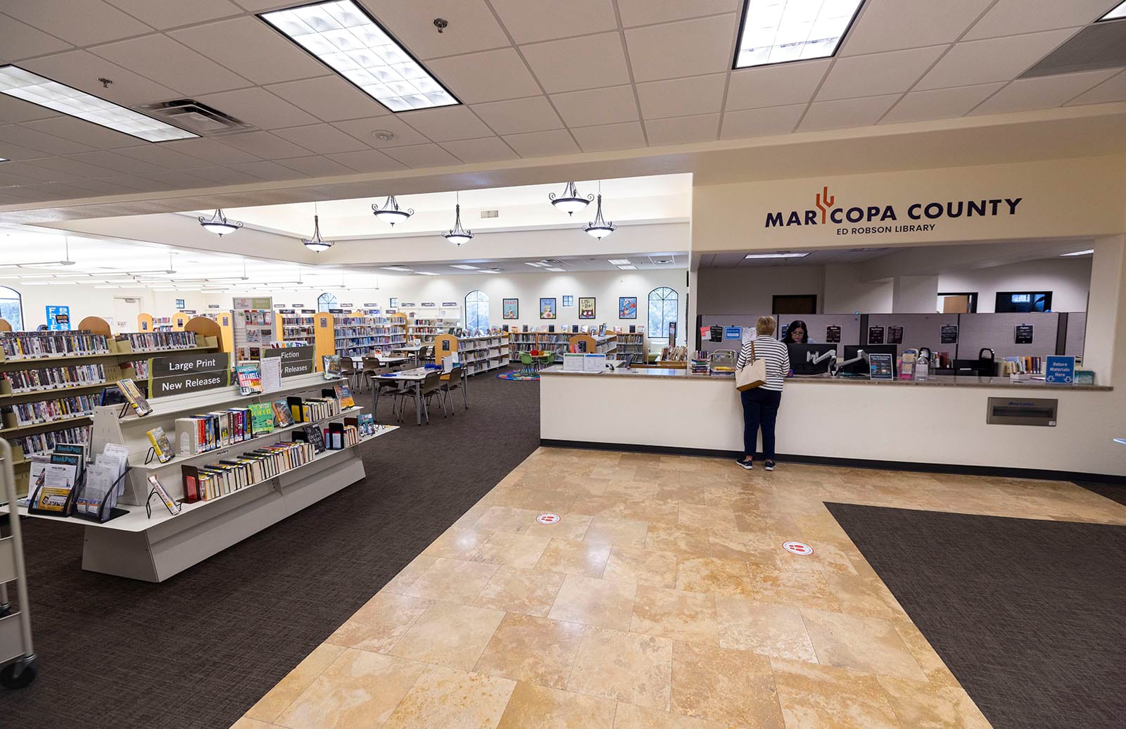 Photo of the service desk and book displays from the entrance of the library